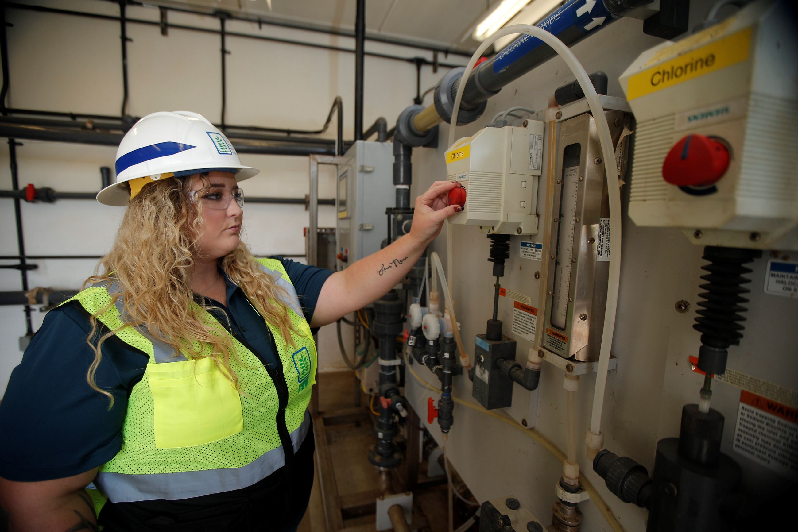 woman water treatment operator turning a dial