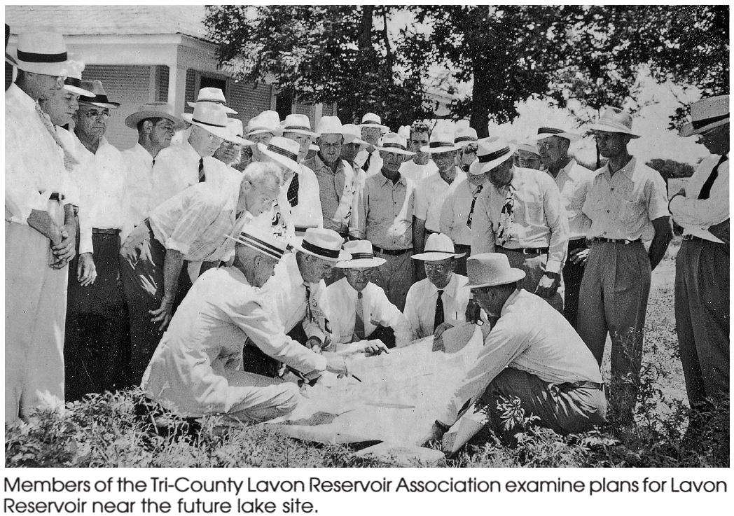 photo with caption of a group of men reviewing lavon reservoir construction plans